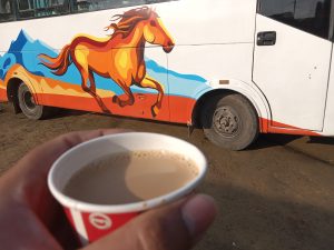 A cup of tea in the morning in front of the horse painted on the bus at Mahendra Highway, Nepal 