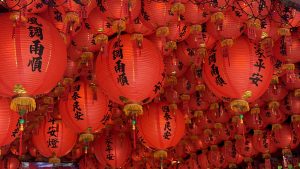 Red lanterns hanging inside Fude Temple in 228 Peace Memorial Park, Taipei, Taiwan. The lanterns are decorated with traditional Chinese characters and are suspended throughout the temple interior.
