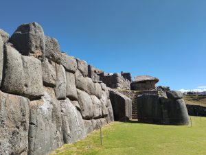 A narrow opening in the massive stone walls at Sacsayhuaman reveals a stone staircase leading to the upper level.