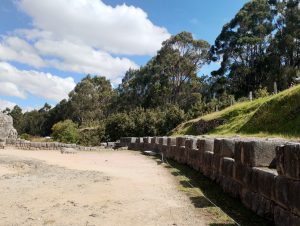 Remains of a large Inca stone structure at Qenqo, near Cusco. Carefully fitted stone blocks form a semicircular wall with openings in its upper rows, enclosing an area believed to be the remains of an Inca ceremonial plaza.
