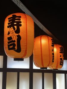 Orange Japanese-style lanterns with black Japanese characters