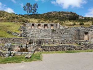 Ruins of Tambomachay, an Inca archaeological site near Cusco, Peru. Three stone water fountains are built into the carefully fitted masonry, with clear water still flowing through the ancient hydraulic system.