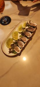 Fresh oysters with lime garnish.