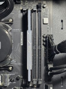 First DDR4 RAM module fully seated in the motherboard DIMM slot with retaining clips locked into place.