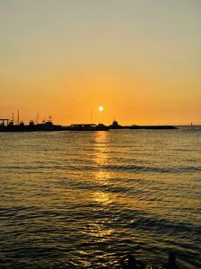 A beautiful sunset at the beach of Santa Teresa with a group of boats at Guanacaste on Costa Rica
