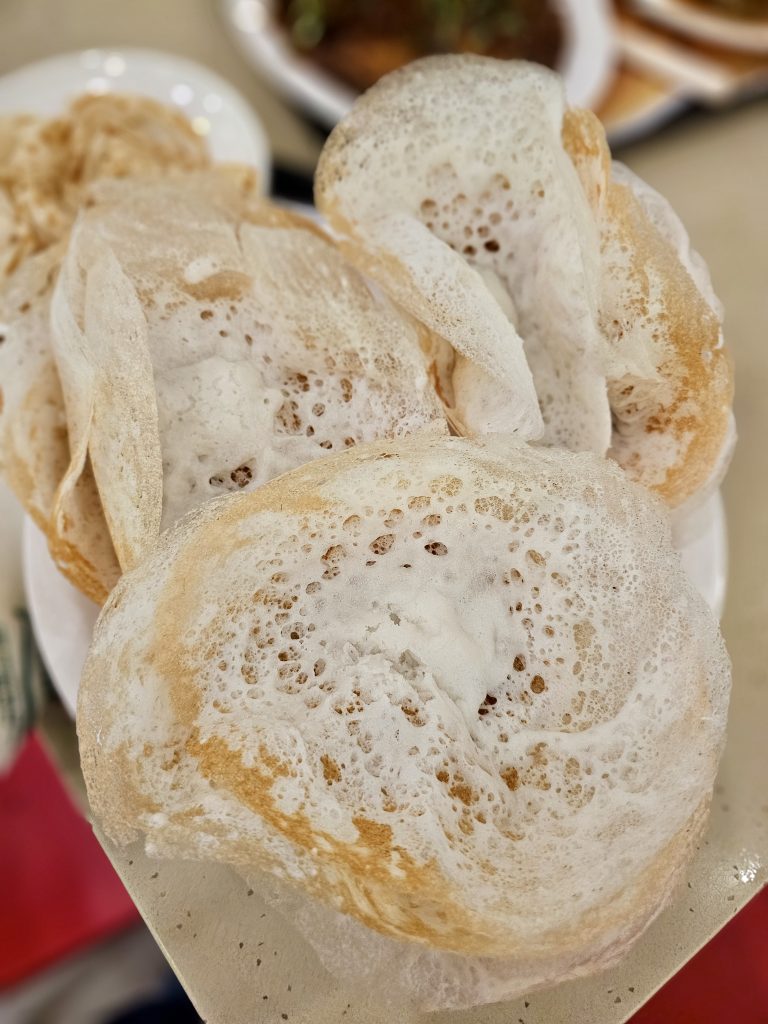 Freshly made Kerala appams with soft, fluffy centers and crisp golden edges. A classic breakfast and dinner favorite that pairs perfectly with stew or curry. Captured in Palazhi, Kozhikode, Kerala.