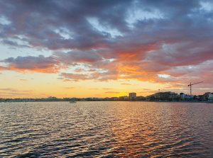 Sunset over the Mar Menor lagoon in San Javier, Murcia, Spain, with colorful clouds and reflections on the water.