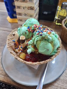 Rainbow sprinkles brighten mint chocolate chip sundae