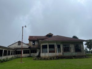 Historic wooden building with weathered walls and a cloudy sky overhead.