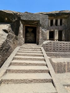 Stone steps lead to the entrance of a cave, where an ancient Buddhist stupa stands. The rock-cut doorway and weathered stone reflect the remarkable history of Kanheri Caves. Captured at Kanheri Caves, Borivali East, Mumbai.