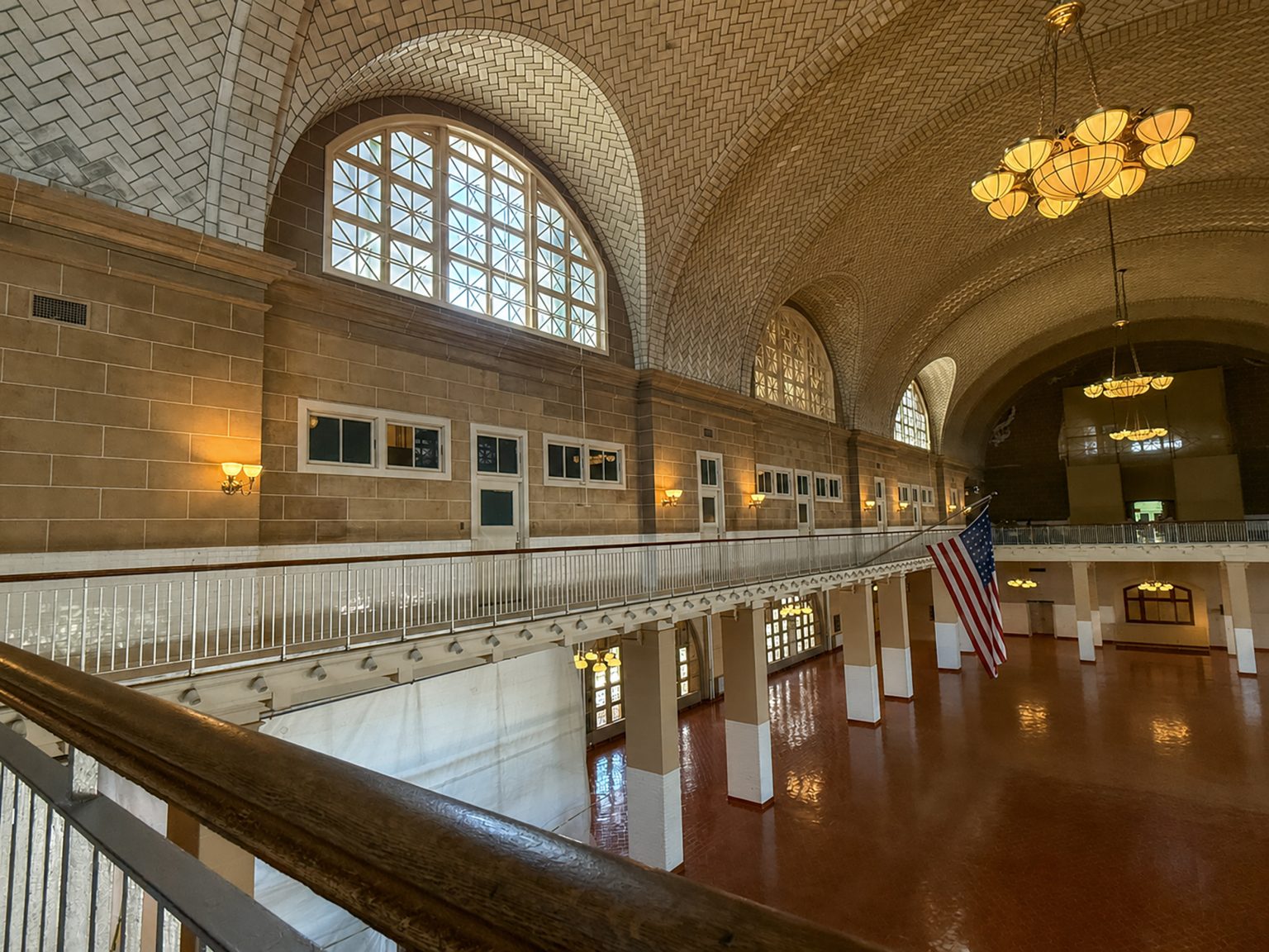 The great hall/registration room in the administration building on Ellis Island, photographed from the second floor looking down.