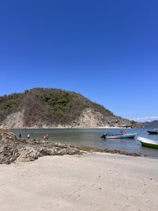 
Tourists and boats on the shore of Isla Tortuga, Costa Rica.