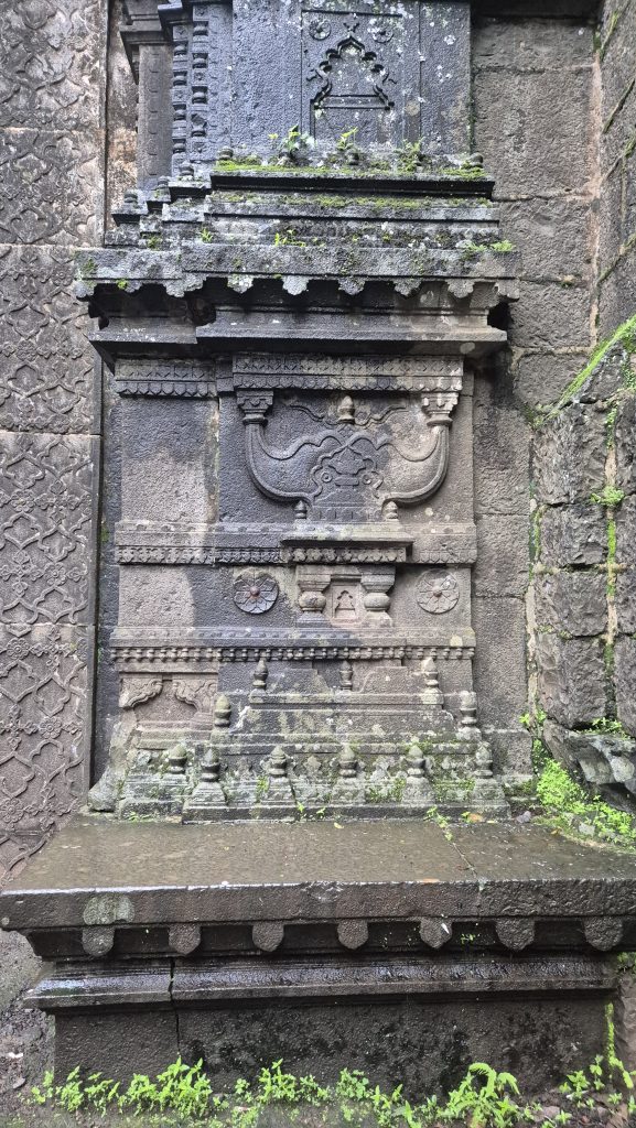 Detailed stone temple structure with carvings and moss.