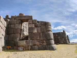 Intipunku, an imposing stone doorway located within the main walls of Sacsayhuaman near Cusco, Peru. The entrance features massive carefully fitted stone blocks.