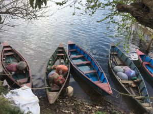 A colorful boat drifting across the tranquil waters of Begnas Lake, Pokhara.