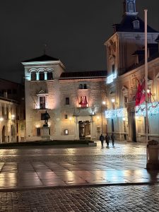 Night view of Plaza de la Villa featuring Casa de la Villa and illuminated historic buildings in Madrid, Spain.
