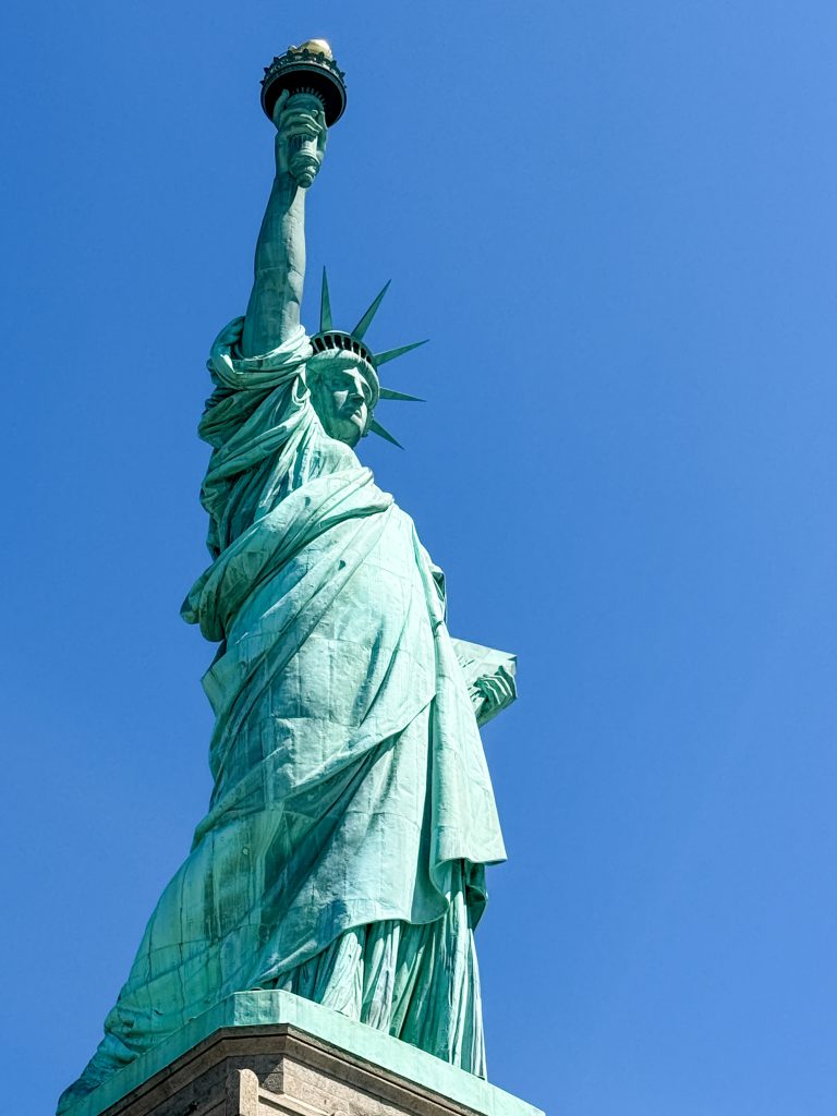 The Statue of Liberty (in New York Harbor). Photographed looking up at the statue from the side.