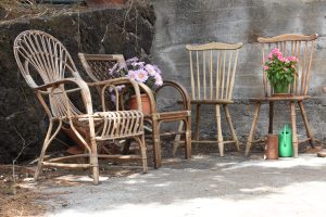 Antique wooden chairs gathered for their meeting on a Sicilian summer day.