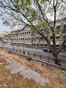 Old stone building along a road in Pune city in India.
