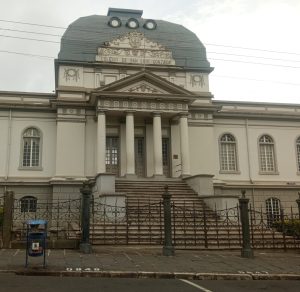 The neoclassical facade of the San Luis Gonzaga High School stands as a landmark of architectural heritage in Cartago, Costa Rica. Arched windows on either side add elegance to the symmetrical composition, reflecting the historic character of one of Costa Rica's most emblematic educational institutions.