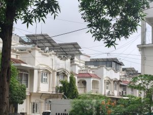 A neighborhood scene showcasing a row of residential buildings with a mix of architectural styles.
