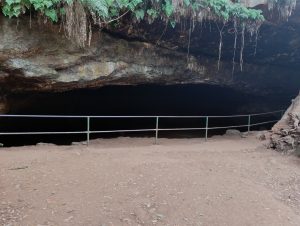 
An open cave with metal railings.
