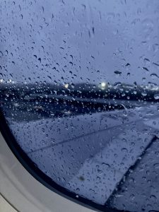 Rain droplets outside the airplane window giving a natural hazy and blurry effects.