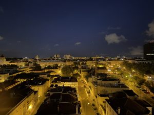 A photo of the Lisbon, Portugal skyline at night. Lights glowing below in the city quiet city streets 