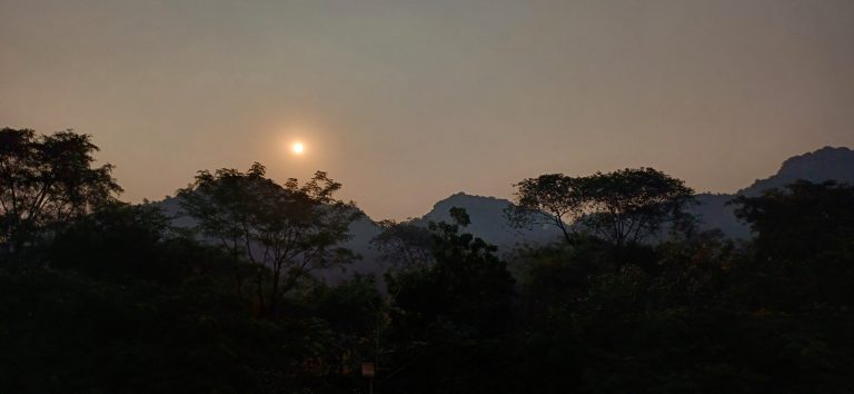 Sunrise Over Forested Hills