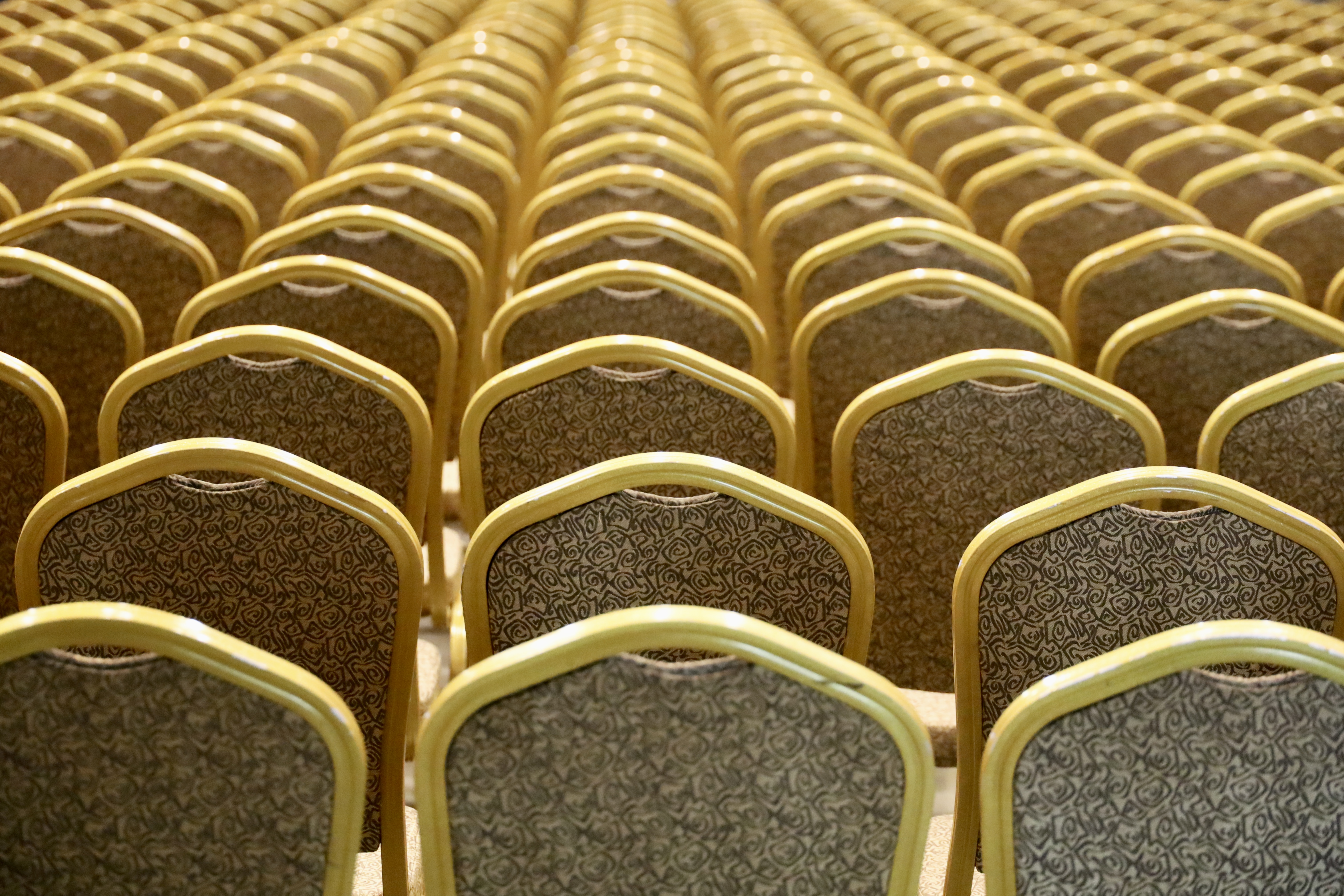 Rows of gold-colored chairs filling the entire frame.