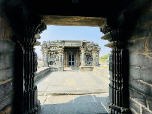 Framed by dark stone pillars, this view looks across the temple courtyard toward another beautifully carved shrine. The natural framing adds depth and draws attention to the temple’s elegant architecture. Captured at Kasivisvesvara (also known as Kavatalesvara or Kashivishveshvara) Temple, Lakkundi (Lokkugundi), Gadag district, Karnataka.
