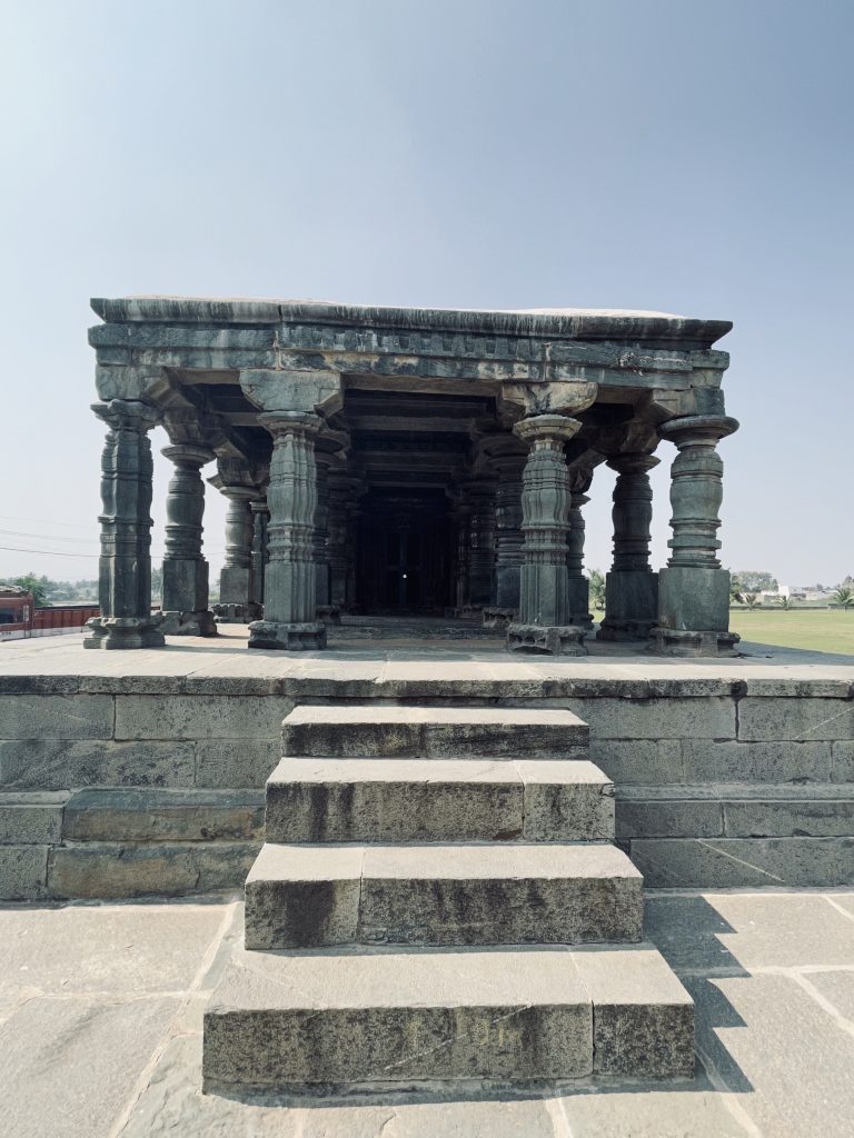 The open pillared hall features massive stone columns supporting a flat roof, creating a peaceful and timeless atmosphere. The simple yet elegant design reflects the temple's architectural brilliance. Captured at the Lakkundi (Lokkugundi) Temple Complex, Gadag district, Karnataka.