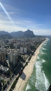 
A panoramic view of a coastal city, with a winding beach stretching along the shoreline.