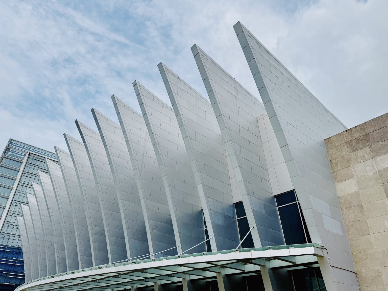 White architectural fins rising above the glass entrance of the Iloilo Convention Center.