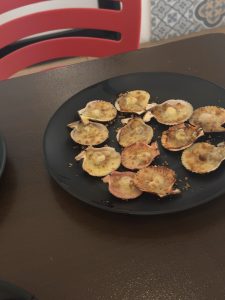 A plate of baked scallops with butter, cheese, and garlic will never go wrong.