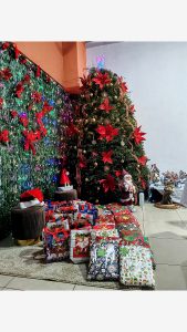 
A decorated Christmas tree with gifts underneath.