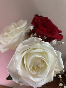 
A close-up photo of a small bouquet featuring three roses. 