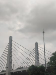 
A modern cable-stayed bridge stands tall against a backdrop of overcast skies. 