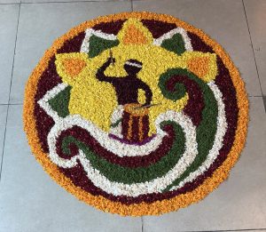 A colorful circular floral design featuring a drummer silhouette surrounded by vibrant petal patterns.