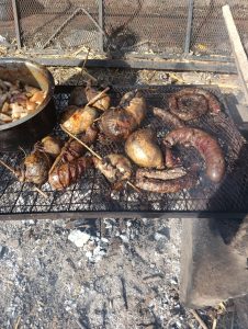 Nyama choma grilling over an open fire.