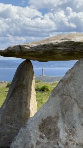 View of the sea and Tower of Hercules through a megalithic stone structure.