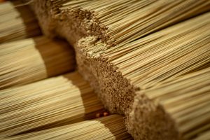 Close-up of bundles of thin sticks of bamboo before they are coated with incense. Taken at an incense stick factory in Vietnam.
