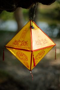 A small, yellow lantern seen in Hue, Vietnam.
