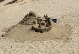Detailed sandcastle and sand fort on the beach.