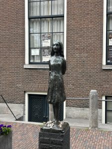 Bronze statue of Anne Frank in front of the Westerkerk in Amsterdam.
