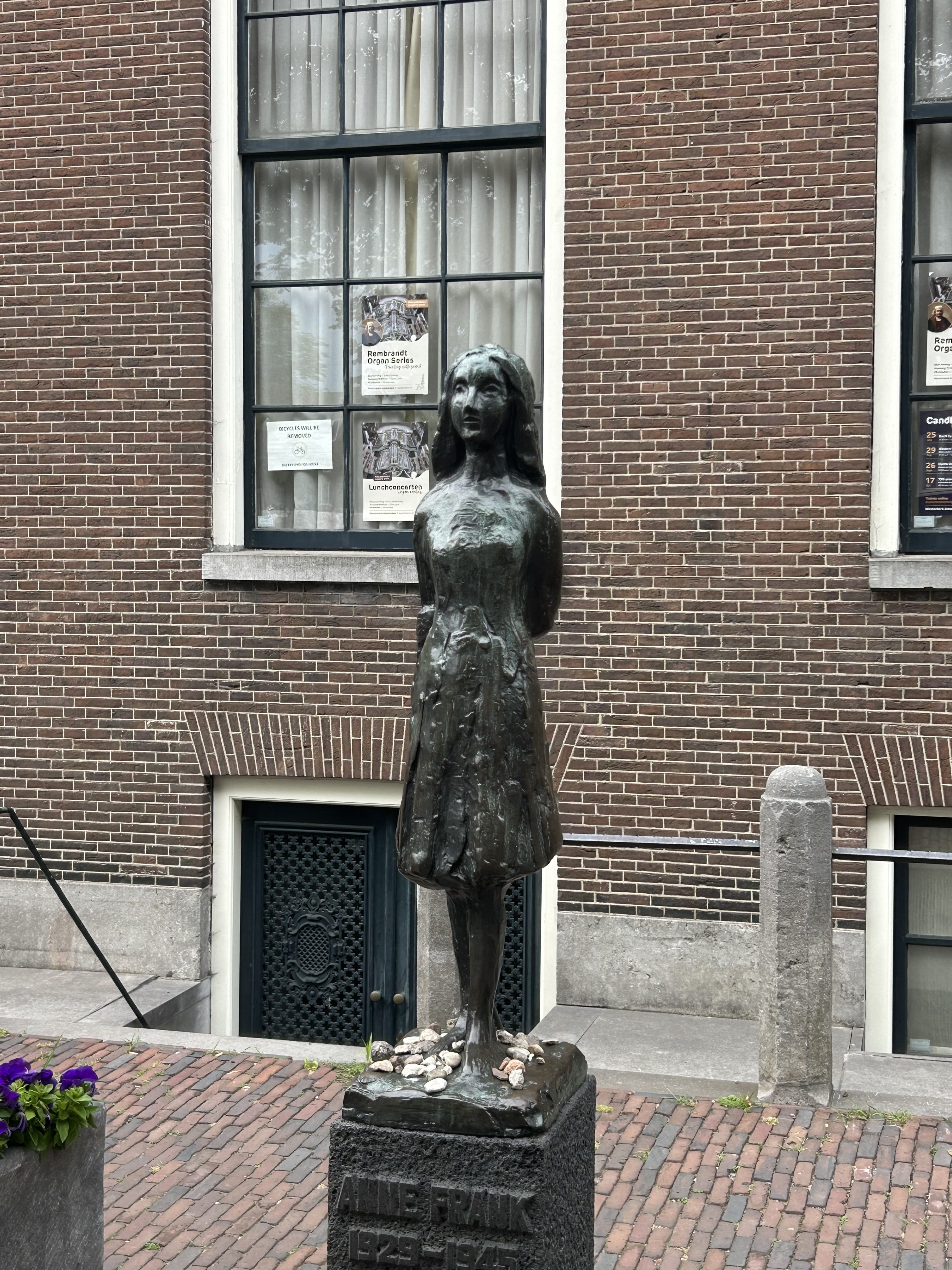 Bronze statue of Anne Frank in front of the Westerkerk in Amsterdam.