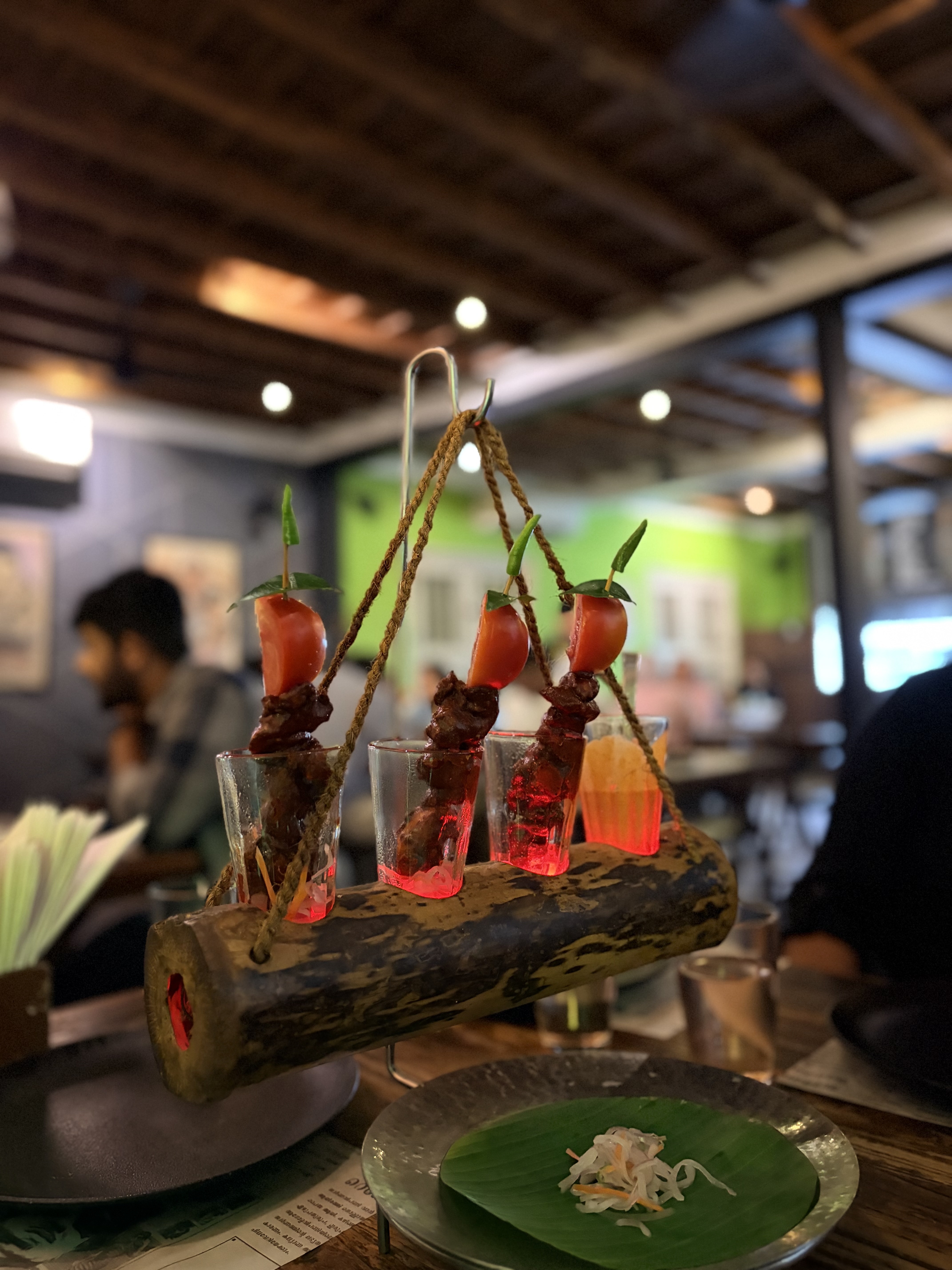 Chicken dish served in small glass arranged on a bamboo