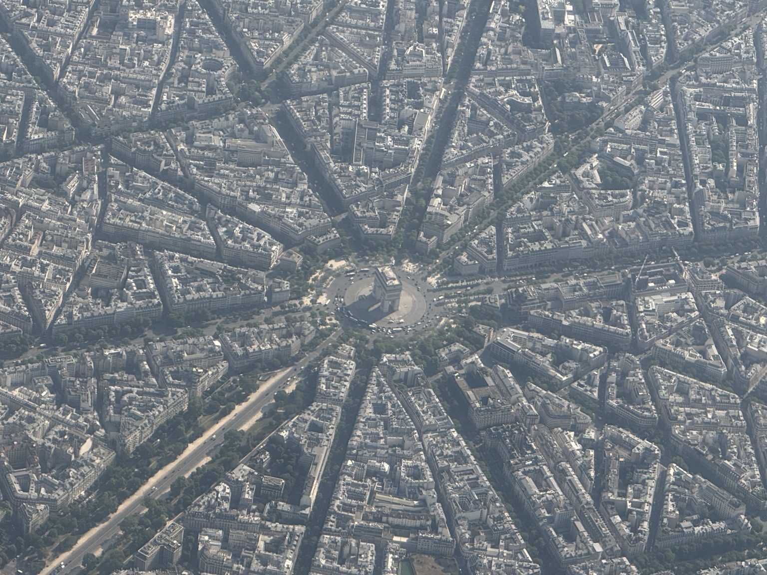 Paris as seen from above with the Arc de Triomph in the center, and the spoke of streets around its traffic circle
