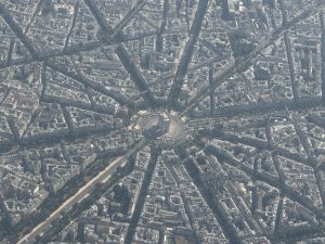 Paris as seen from above with the Arc de Triomph in the center, and the spoke of streets around its traffic circle