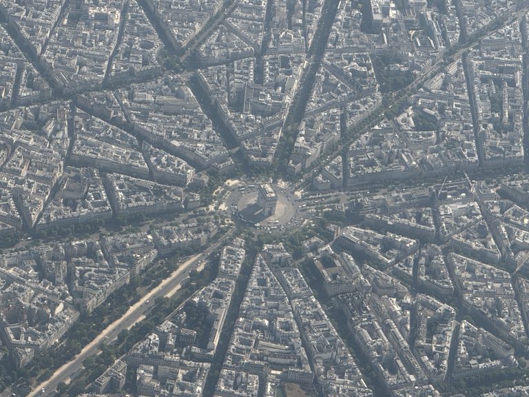 Paris as seen from above with the Arc de Triomph in the center, and the spoke of streets around its traffic circle